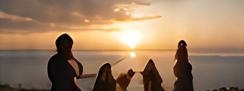 Friends watching the sunset by the sea