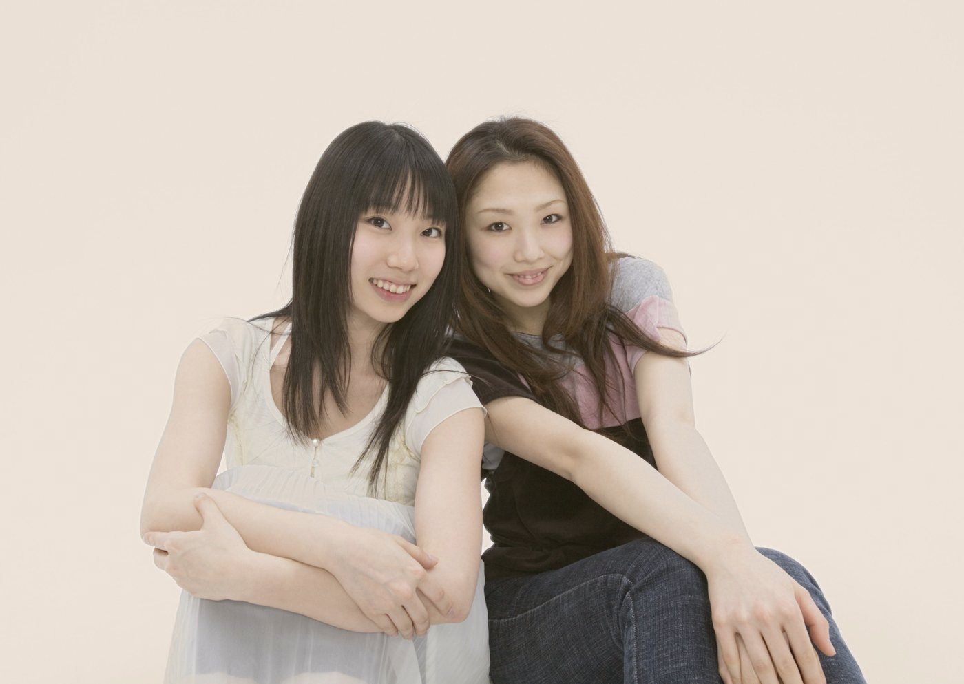 Two friends sitting close and smiling
